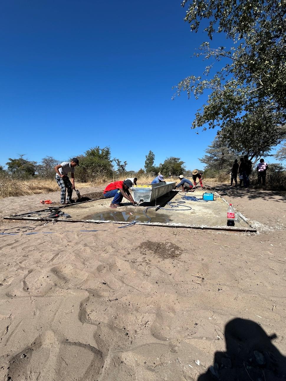 Field team performing maintenance on community water infrastructure